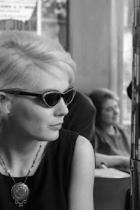 Blonde woman with sunglasses sitting in cafe
